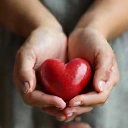 Heart with hands symbolizing ethical practices.